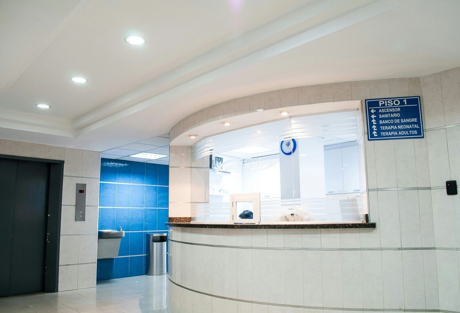 A reception desk in an office building with blue lighting.