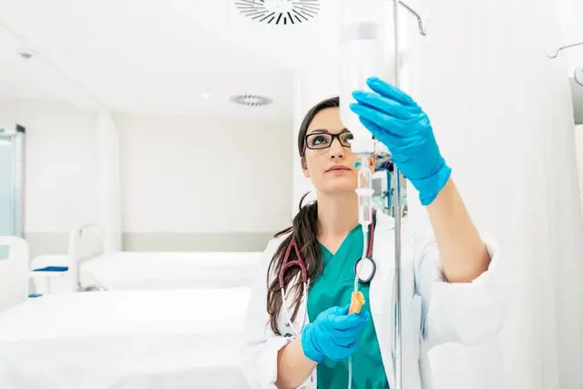 A female doctor is holding a stethoscope in her hand.